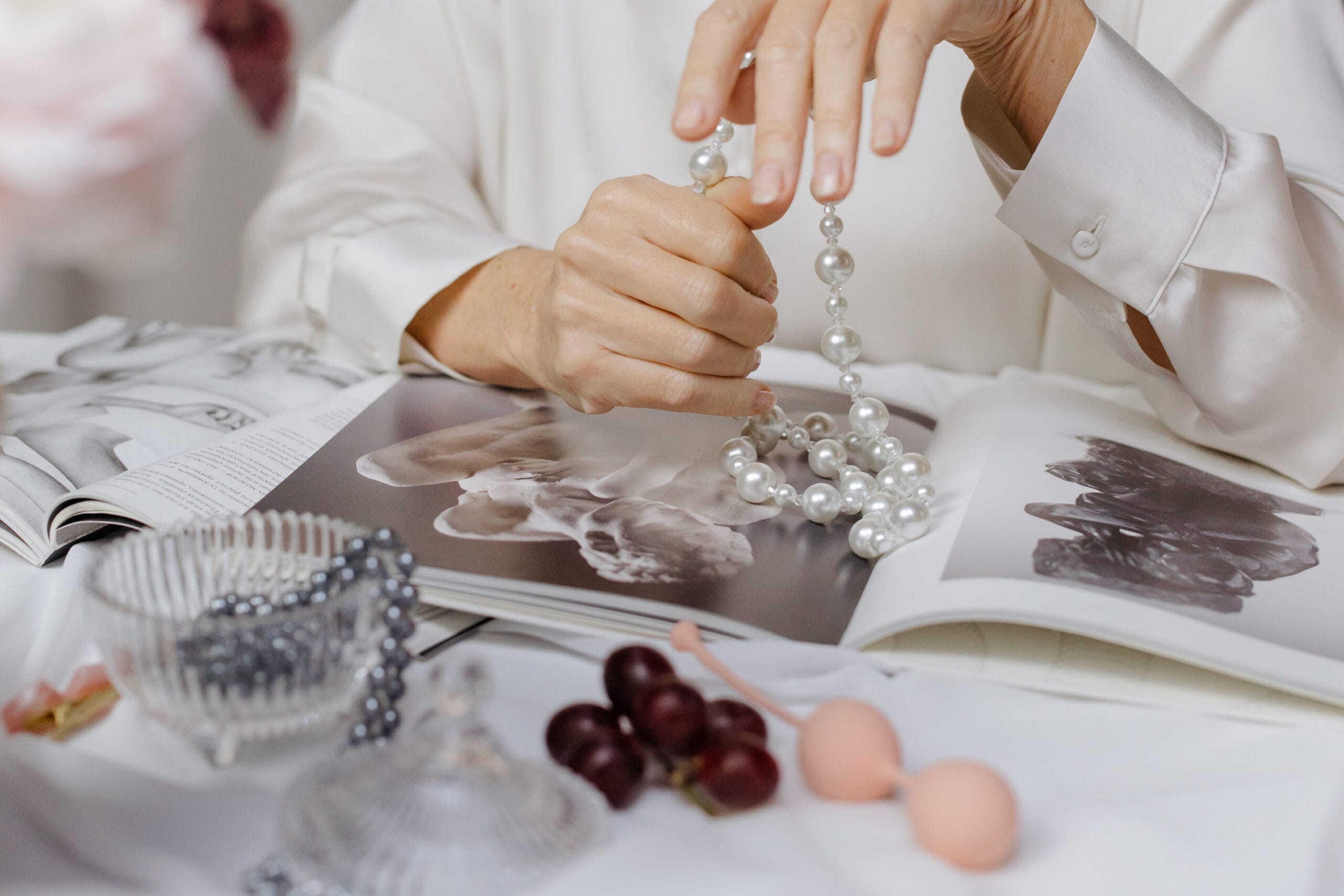 pearl necklace lifestyle elegant table setting with fashion magazines and pearls