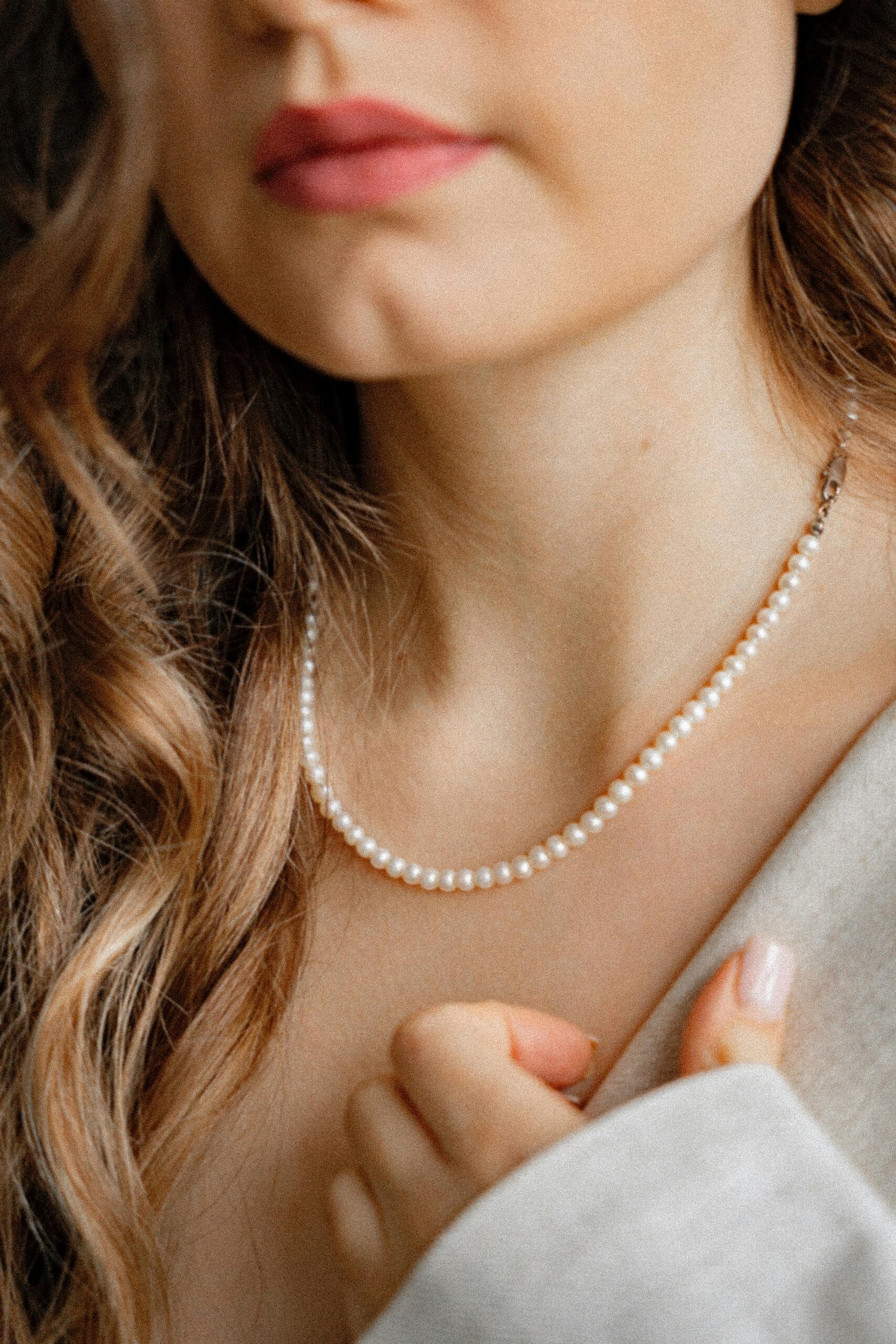 Woman wearing a classic freshwater pearl necklace — timeless elegance