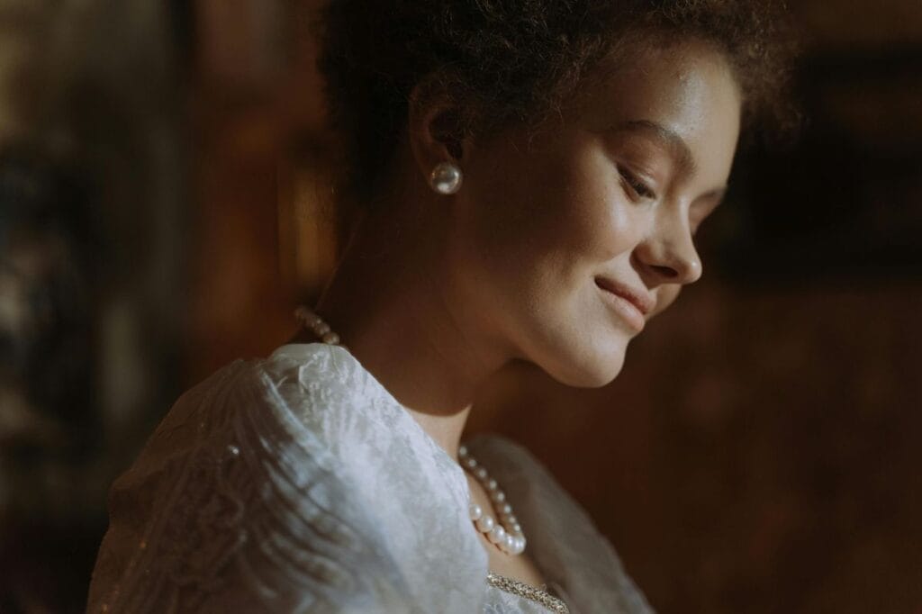 Elegant woman wearing a pearl necklace, illustrating how pearl grading affects real-world appearance