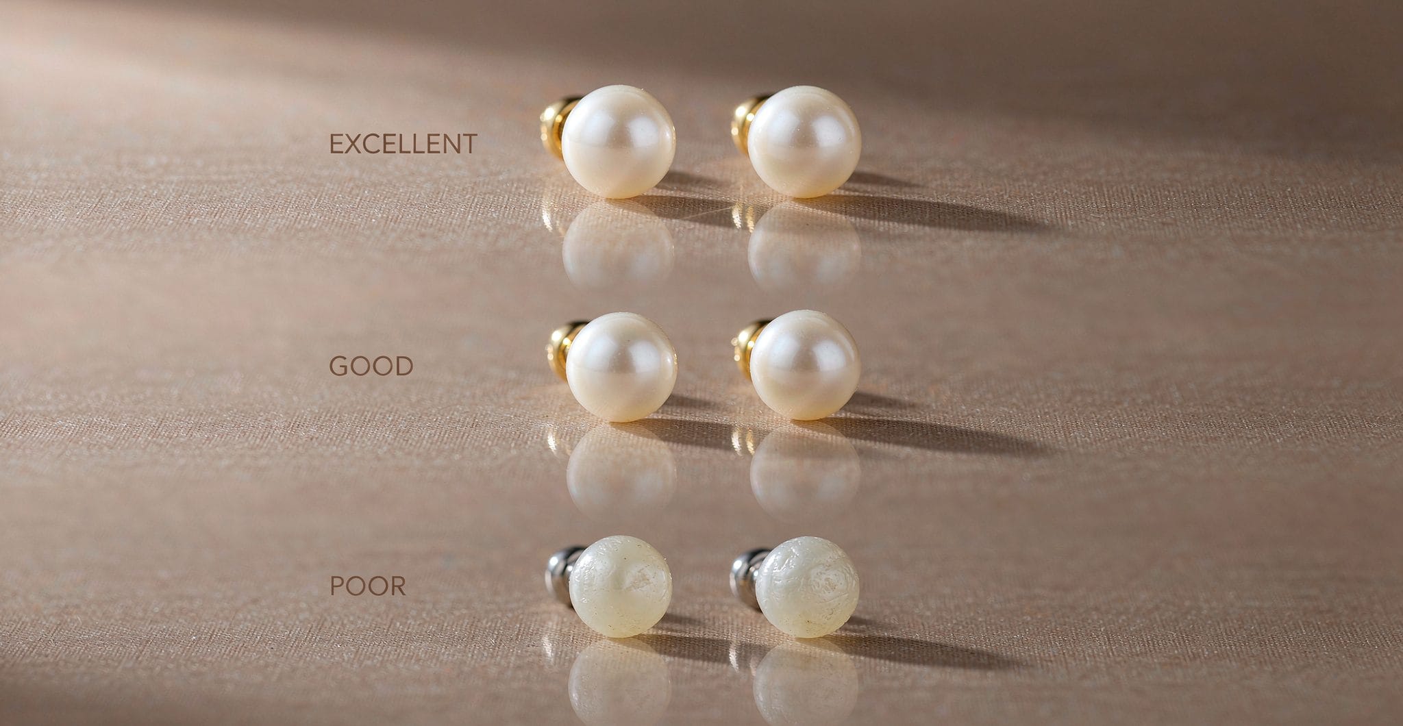 Pearl earring quality grades - excellent, good, and poor luster compared on linen