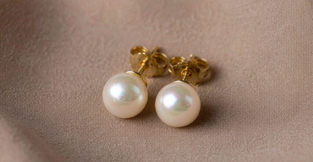 7-8mm classic freshwater pearl stud earrings with 14K gold post back, on neutral linen background