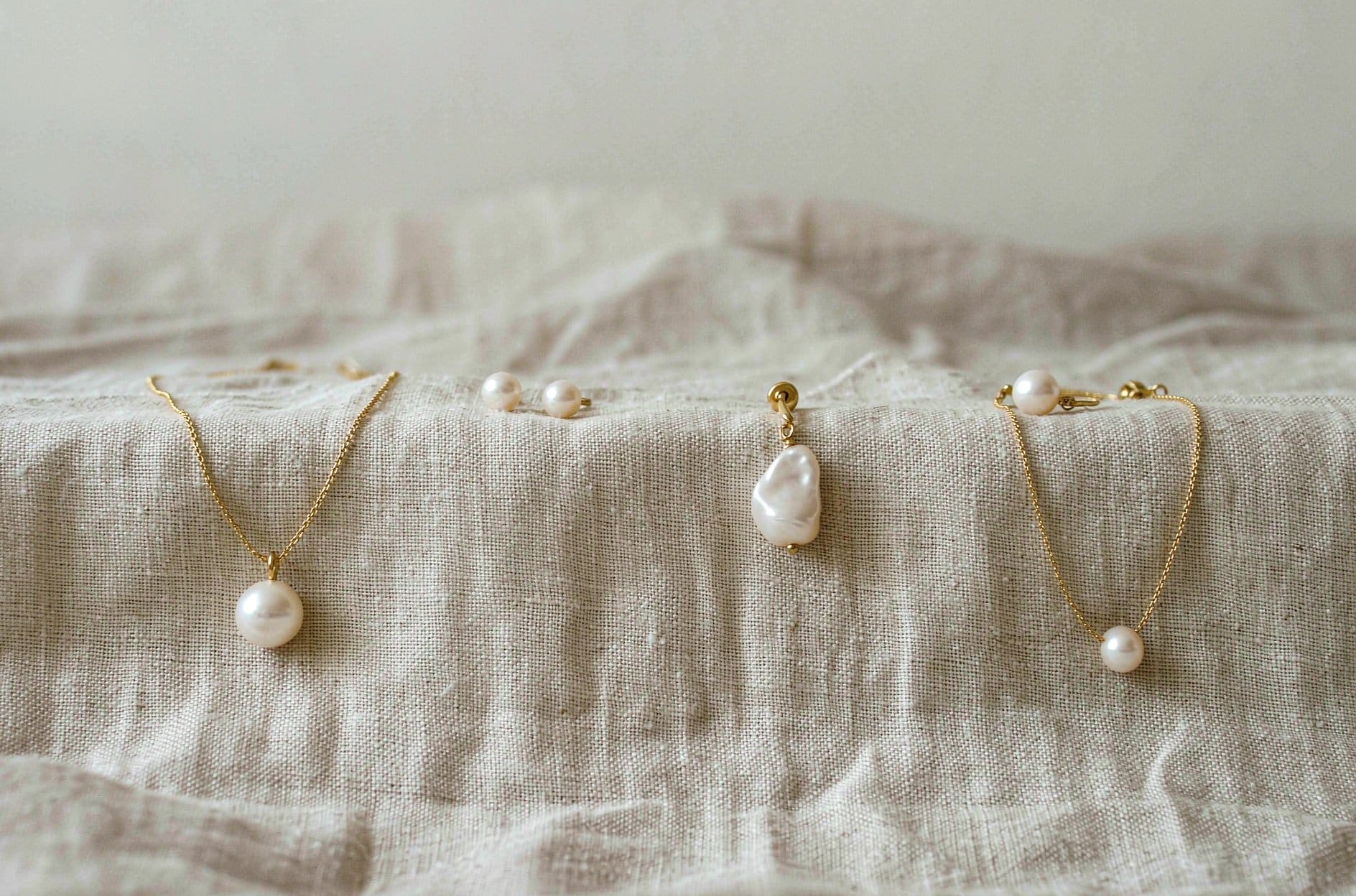 Pearl anniversary gift by budget - three pearl necklaces representing different price tiers