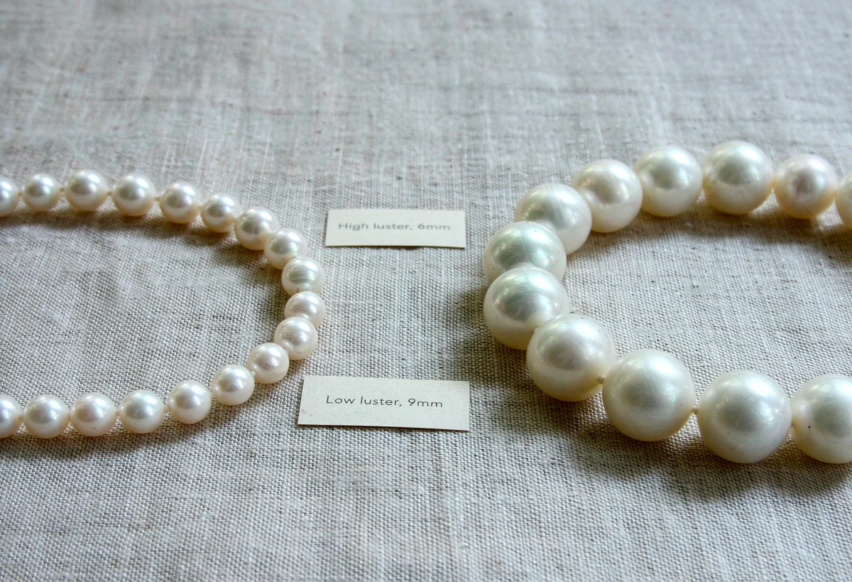 High-luster 6mm versus low-luster 9mm pearl necklace, proving luster matters more than size or certificate.