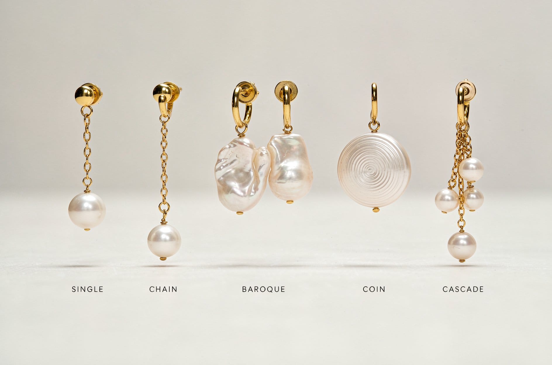 Five pearl drop earring styles comparison: single, chain, baroque, coin, and cascade