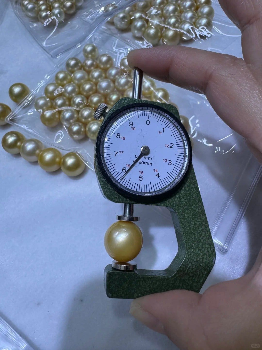 Freshwater pearls measured by caliper for size grading