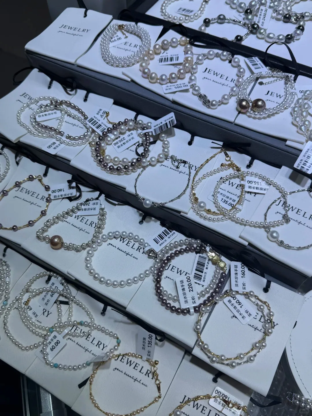 Pearl jewelry displayed at a Zhuji market stand, showing real pricing labels and variety for budget shoppers.